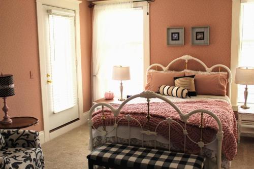 a bedroom with a bed with pink walls at The Nordic Pineapple Bed and Breakfast in Saint Johns