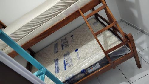 a bunk bed in a room with a mattress at Matinhos 150 metros da praia in Matinhos