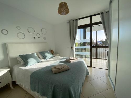 a bedroom with a bed with a towel on it at Jandia Beach Apartment in Morro del Jable