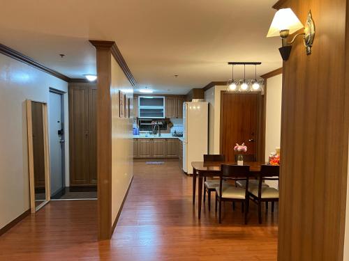 a kitchen and dining room with a table and a dining room at Darah Pines' Homestay in Baguio