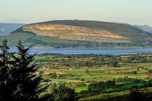 a view of a hill with a lake and a mountain at Cosy family home in Strandhill in Sligo