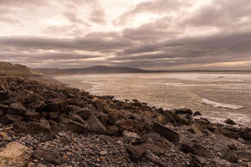 a group of rocks on the shore of the ocean at Cosy family home in Strandhill in Sligo