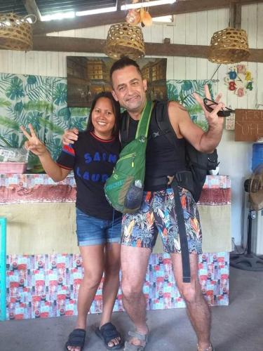a man and a woman posing for a picture at Paraiso Hostel Moalboal in Moalboal