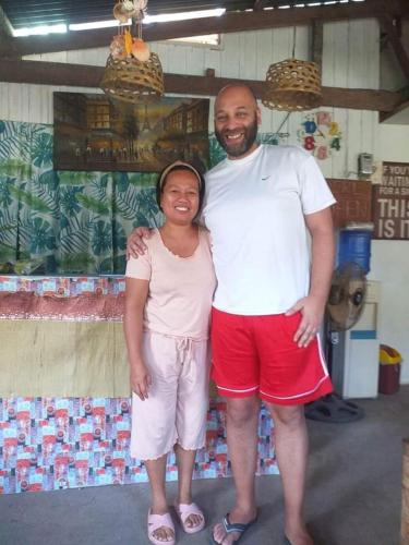 a man and a woman posing for a picture at Paraiso Hostel Moalboal in Moalboal