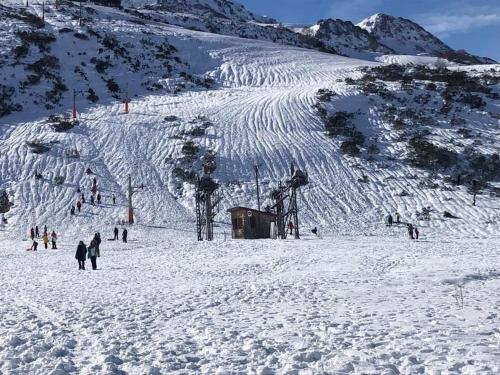 a group of people skiing down a snow covered mountain at APARTAMENTO Estación de ESQUÍ EN SAN ISIDRO in San Isidro