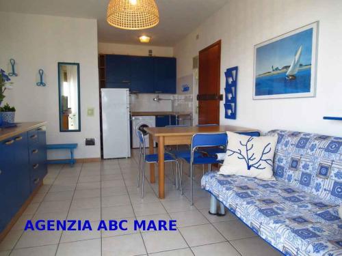 a living room with a couch and a table and a kitchen at Apartment in Porto Santa Margherita 43993 in Porto Santa Margherita di Caorle