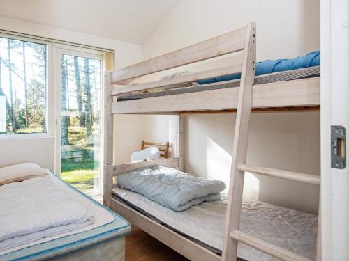 a bedroom with two bunk beds and a window at Two-Bedroom Holiday home in Harboøre 4 in Harboør