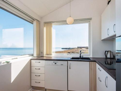 a kitchen with a view of the ocean at 6 person holiday home in Harboøre-By Traum in Harboør