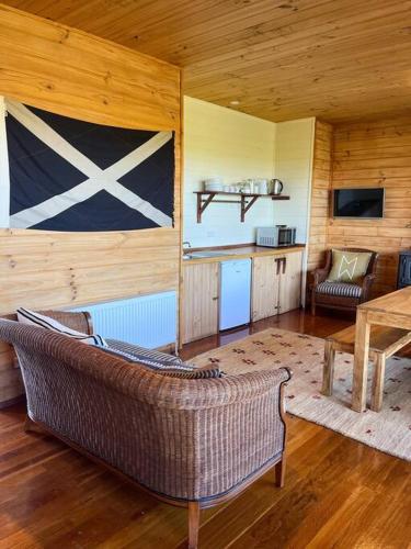 a living room with a couch and a table at Pt Hesse Luxury Coastal Homestead in Port Campbell
