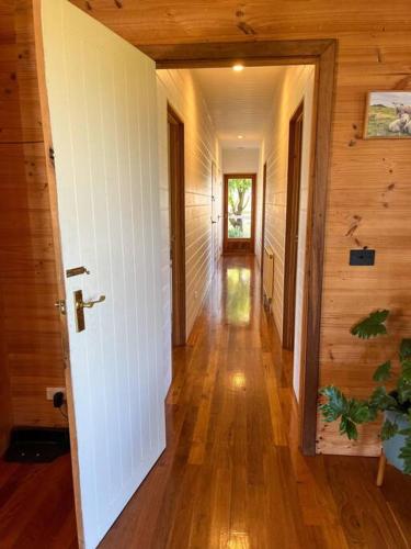 a hallway of a house with a door and wooden walls at Pt Hesse Luxury Coastal Homestead in Port Campbell