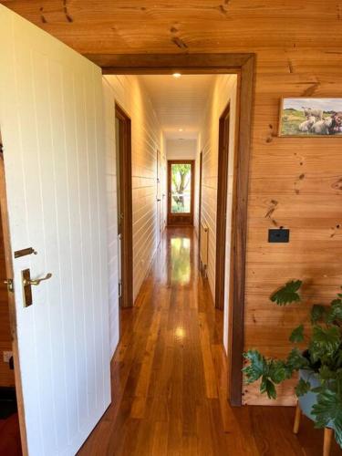 a hallway of a house with wooden walls and wood floors at Pt Hesse Luxury Coastal Homestead in Port Campbell