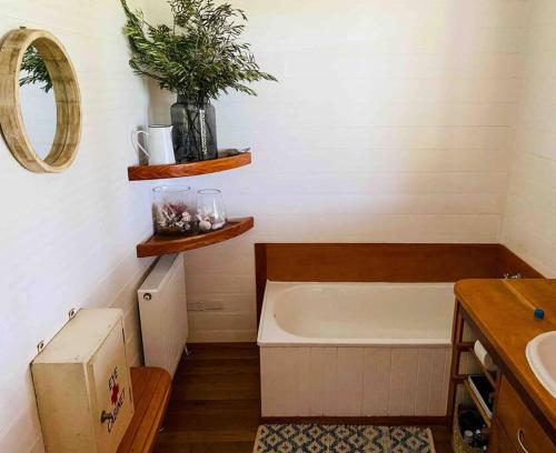 a bathroom with a bath tub and a sink at Pt Hesse Luxury Coastal Homestead in Port Campbell