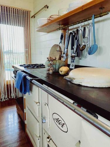 a kitchen with a stove and a counter top at Pt Hesse Luxury Coastal Homestead in Port Campbell
