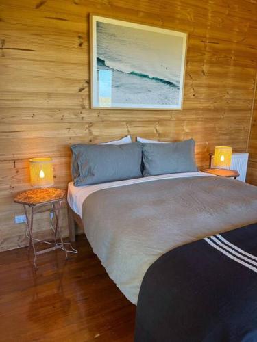 a bedroom with a large bed with two lamps on tables at Pt Hesse Luxury Coastal Homestead in Port Campbell