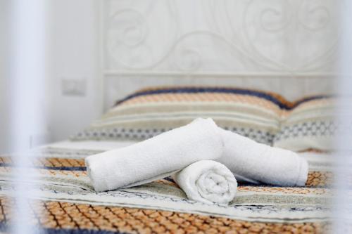 a roll of toilet paper sitting on a bed at Apulia Modern apartment - Bari Airport in Bitonto
