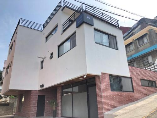 an apartment building with a staircase on top of it at Cheukhu-dong 19street Guesthouse in Mokpo