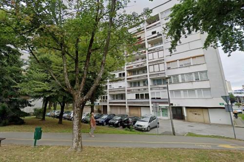 a person walking in front of a building at Apartments with a parking space Karlovac - 20779 in Karlovac