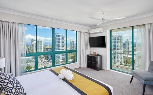 a hotel room with a bed and a large window at Crown Tower by Serain Residences in Gold Coast