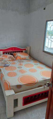a large bed in a room with a window at HOSTAL ZAS in Mompos
