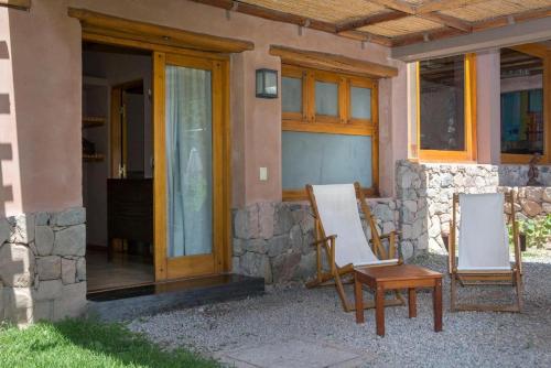 a couple of chairs sitting outside of a house at Las Marías Hotel Boutique in Tilcara