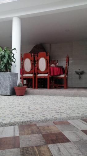 a bedroom with two chairs and a table with at Villa Myrian in Villanueva