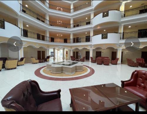 a large lobby with chairs and a couch and tables at "Красавиците тъмнокоси" Sunset Resort Pomorie in Pomorie