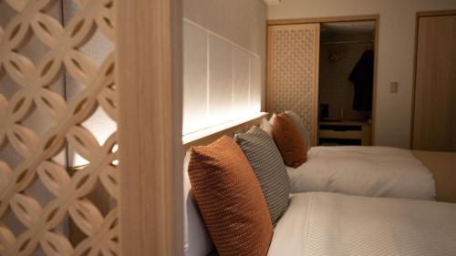 a bedroom with two beds and a window at Kinugawa Onsen Hotel in Nikko