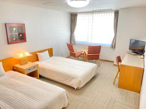 Postel nebo postele na pokoji v ubytování Hotel Shinanoji