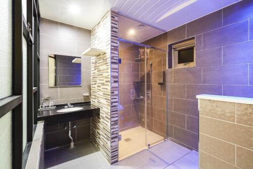 a bathroom with a shower and a sink at Hoengseong Haru Self check-in Hotel in Hoengsong