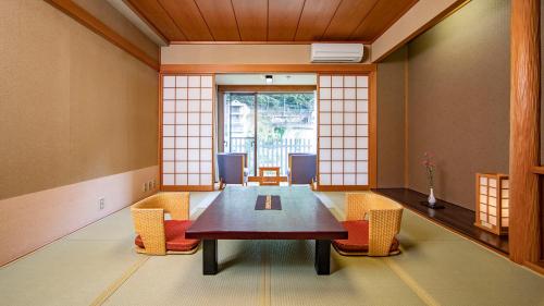 a dining room with a table and chairs at Kinugawa Onsen Hotel in Nikko
