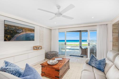 a living room with a view of the ocean at Mariners 1 in Mollymook