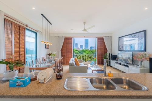 a kitchen with a sink and a living room at Park view Avalon Apartment District 1 HCM City in Ho Chi Minh City