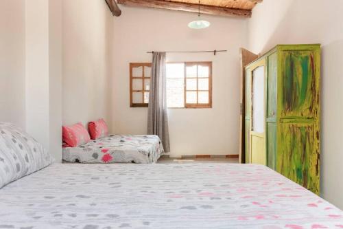 a bedroom with two beds and a window at Las Juanas in Eugenio Bustos