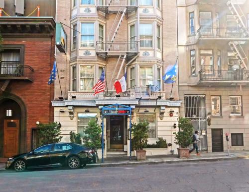 a car parked in front of a building with flags at Cornell Hotel de France in San Francisco