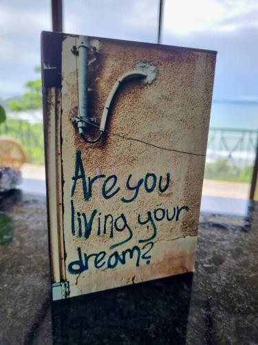 a sign that says are you winning your dream at Villa Amor del Mar with Breathtaking View of Ocean & Jungle in Dominical