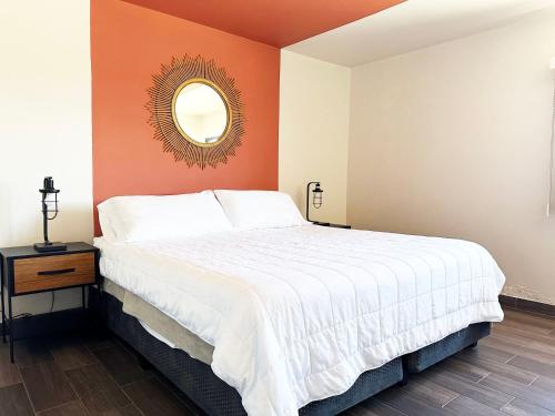a bedroom with a large bed and a mirror at Stella del Mar in San Felipe