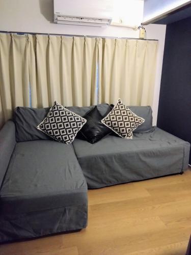 a couch with two pillows on it in a living room at 板橋 RCアネックス Rc201 in Tokyo