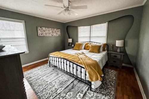 a bedroom with a bed and a ceiling fan at Nichol's Nest in Anniston