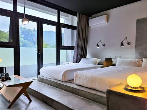 a bedroom with a large bed and a large window at Delight Inn in Yanqing