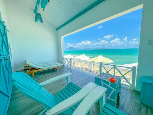 a balcony with chairs and a view of the ocean at Paradise Resort Doc Let - All Inclusive in Doc Let