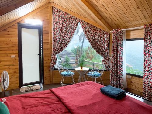 a bedroom with a bed and a large window at Mimosa Villa in Vĩnh Phúc