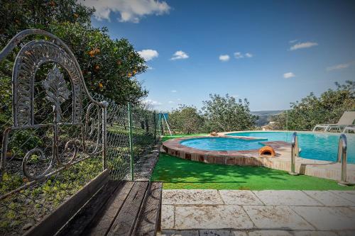 a swimming pool with a dog laying in it at Casa Adega - Quinta Amoreira in Faro