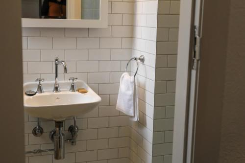 a bathroom with a sink and a towel at Alpine Hotel, Eat Drink Sleep in Warburton