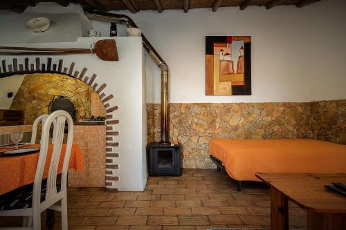 a bedroom with a bed and a brick fireplace at Casa Do Forno - Quinta Amoreira in Faro