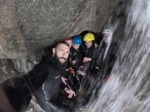 a group of people in a cave near a waterfall at Accommodation Konak in Žabljak
