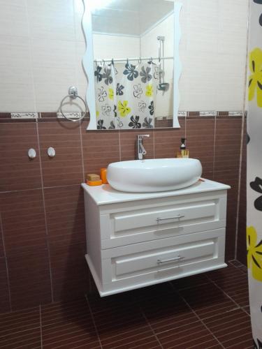a bathroom with a sink and a mirror at 2-storey apartment in Mardakan