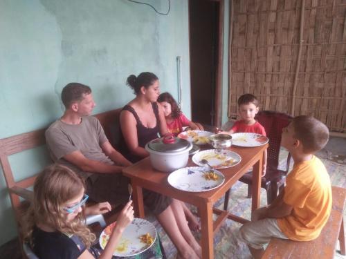 a group of people sitting around a table at Subansiri lodge in Majuli