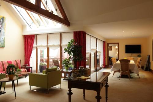 a large living room with a table and chairs at Hotel Restaurant "Le Strasbourg" in Bitche