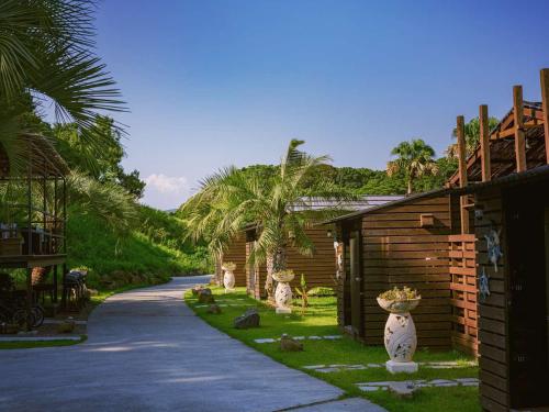 a house with a road next to a building at Glamping village Seagrand in Matsuura