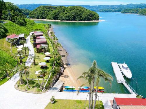a view of a beach with a boat in the water at Glamping village Seagrand in Matsuura